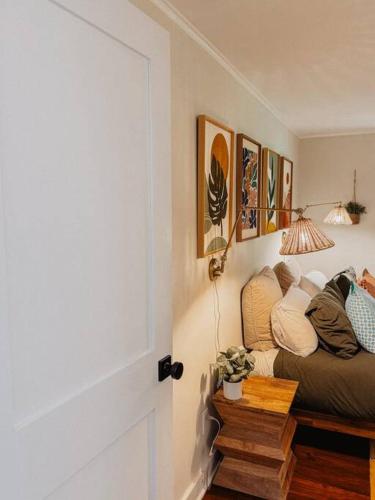 a room with a couch and some pictures on the wall at Creek Side Cabin with Wood Fired Hot Tub and Fire Pit in New Milford