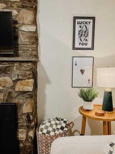 a living room with a table and a fireplace at Creek Side Cabin with Wood Fired Hot Tub and Fire Pit in New Milford