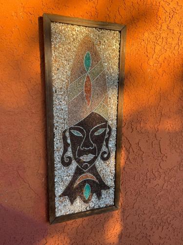 a mosaic picture of a woman on a wall at Center Street Villas in Joshua Tree