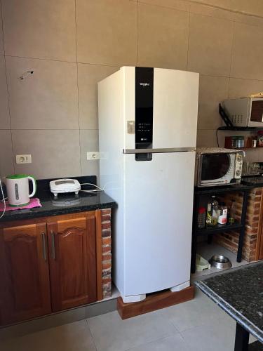 a large white refrigerator in a kitchen at Casa de verano en San Bernardino in San Bernardino