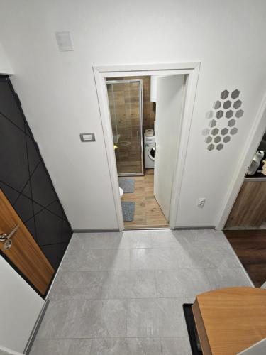 a hallway leading to a bathroom in a house at Modern Apartment S22 in Niš