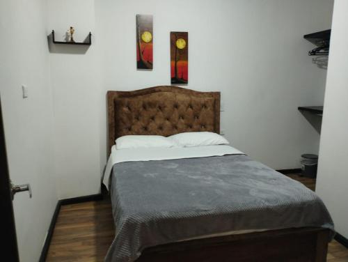 a bedroom with a large bed with a wooden floor at Hotel Casa Real Málaga Santander in Málaga