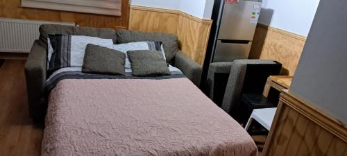a bed in an rv with two pillows on it at Departamentos Kitkaika in Punta Arenas