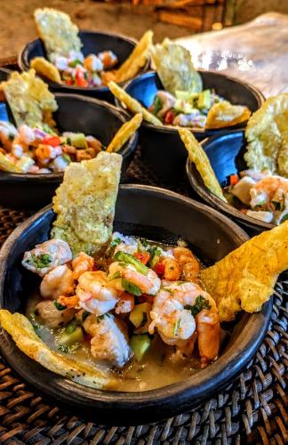 a plate of food with shrimp and corn chips at La Mar de Bien in Buritaca