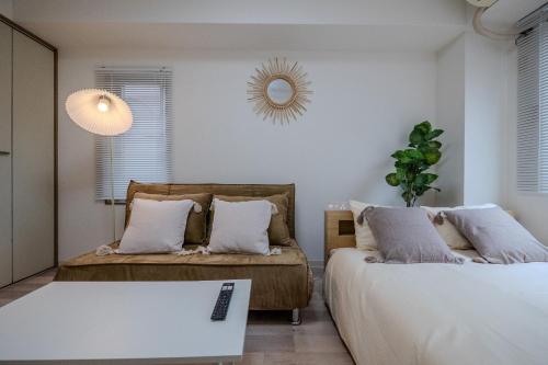 a bedroom with two beds and a mirror on the wall at #8 -アイムタウン南葛西- Entire Unit in Tokyo