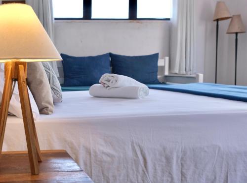 a bed with a stuffed animal on a pillow at Restaurante & Pousada Gaivota in Santo André