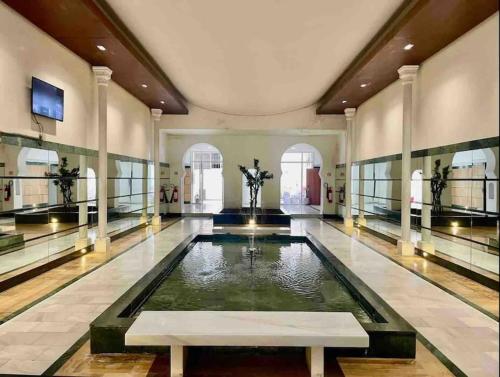 a large room with a pool of water in a building at The Ocean Glimpse - 2 BR Comfort & Sea View in Tangier