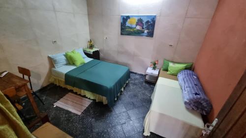 Postel nebo postele na pokoji v ubytování Hostal Jardín de Luque
