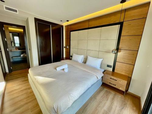 a bedroom with a large white bed in a room at Golden Sand Apartment - Terrace & OceanView 2BD in Tangier