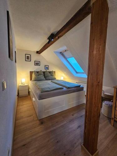 a bedroom with a large bed in a attic at FeWo Wittig am Kulturbahnhof 2 in Leisnig