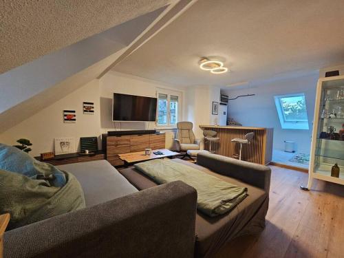 a living room with a couch and a flat screen tv at FeWo Wittig am Kulturbahnhof 2 in Leisnig