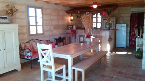 a dining room with a wooden table and chairs at Le Mazet De Jean in Le Cailar
