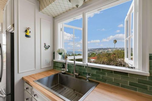 a kitchen with a sink and a large window at The Porter House - Sweeping Ocean Views - La Jolla in San Diego