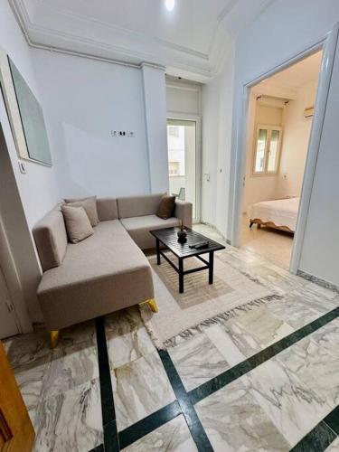 a living room with a couch and a table at T2 à louer à menzah 7bis in Tunis