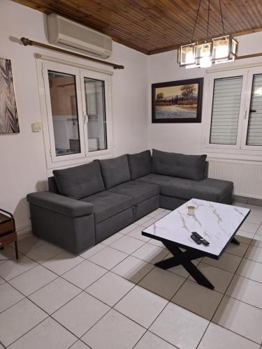 a living room with a couch and a coffee table at Jimmy's House in Mavrommátion