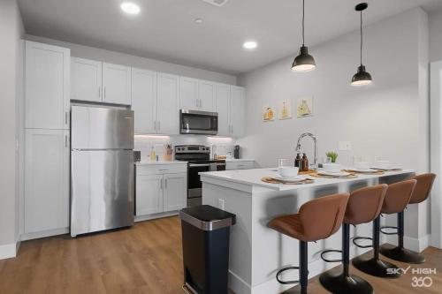 a kitchen with white cabinets and a white refrigerator at Exec King Suites Pool, Gym, Walmart Hq,gym in Rogers