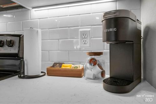 a kitchen counter with a coffee maker on the counter at Exec King Suites Pool, Gym, Walmart Hq,gym in Rogers