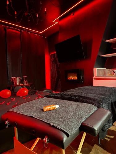 a red room with a bed and a fireplace at Love Room, L'interdit in Rouen
