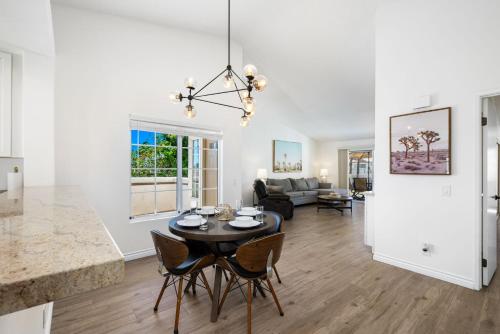 a kitchen and living room with a table and chairs at Newly Renovated Condo in Palm Desert in Palm Desert
