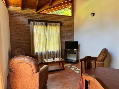 a living room with a table and a television at Okin5 in Costa del Este
