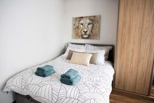 a bedroom with a bed with two towels on it at Apartament pod Katedra w Gnieznie in Gniezno