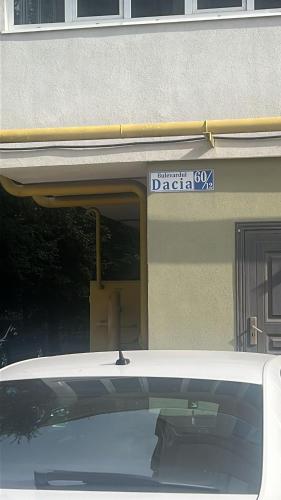 a white car parked in front of a building at Аэропорт Апартаменты Комфорт in Chişinău
