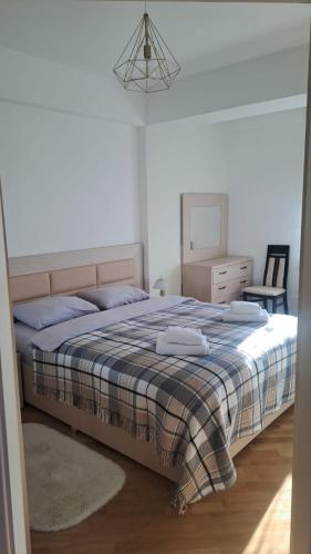 a bedroom with a bed with blue pillows and a dresser at Аэропорт Апартаменты Комфорт in Chişinău