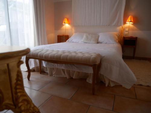a bedroom with a large bed with a large window at Le relais d'Angélique in Lunel