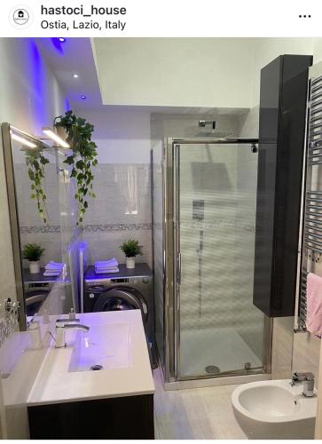 a bathroom with a shower and a sink at Hastoci House in Lido di Ostia