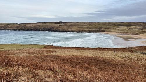 a beach with the ocean and the shoreline at Pentland view croft with a sea view in Melvich