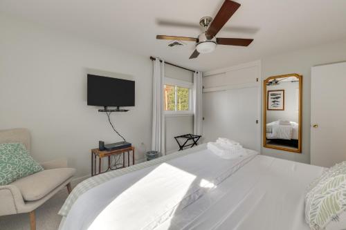 a white bedroom with a bed and a tv at Waterfront Home with Dock in Chesapeake Bay Area! in Lancaster