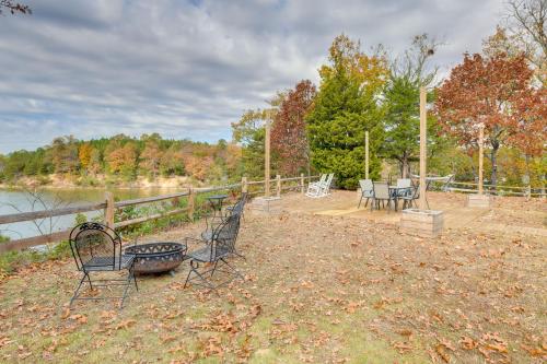 a group of chairs and a table next to a fence at Waterfront Home with Dock in Chesapeake Bay Area! in Lancaster
