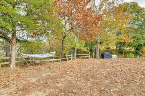 a hammock in front of a fence with trees at Waterfront Home with Dock in Chesapeake Bay Area! in Lancaster