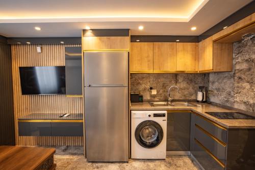 a kitchen with a refrigerator and a washing machine at ISTANBUL SUITE in Istanbul