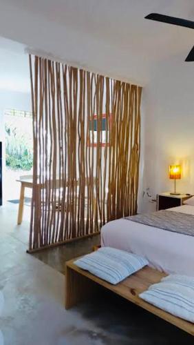 a bedroom with a bed and a wooden wall at NEW MORINGA in Las Terrenas
