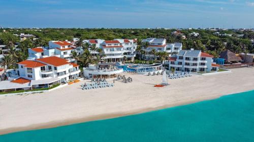an aerial view of a resort on the beach at SUNSET FISHERMEN BEACH & SPA RESORT-Optional All Inclusive- 3 UNITS CHOICE-ROOM - 344A Ocean view with terrace- ROOM 344B No terrace, View from window to park - STUDIO 344C Ocean View Studio for 2- Playacar, Phase 1 in Playa del Carmen