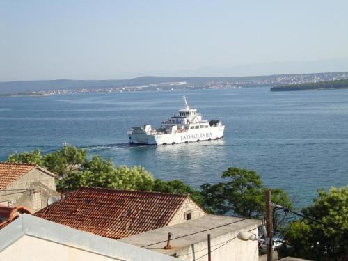 a large white boat in the water at Apartment Kreso in Tkon