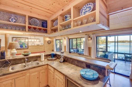 a kitchen with wooden cabinets and a large counter top at Beautiful Lake Keowee Home with Boat Dock and Fire Pit in Seneca