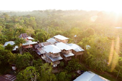an aerial view of a house in the forest at La Ceiba, Amazonas in Leticia