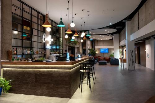 a lobby with a bar with chairs and a couch at Hotel Convictus Cracovia for business & travellers in Kraków