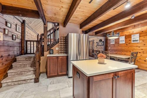 a kitchen with a refrigerator and a dining room at Breck Mountain Home Near Main Street and Trails in Blue River
