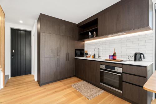 a kitchen with wooden cabinets and a counter top at Best Day Ever in Wanaka