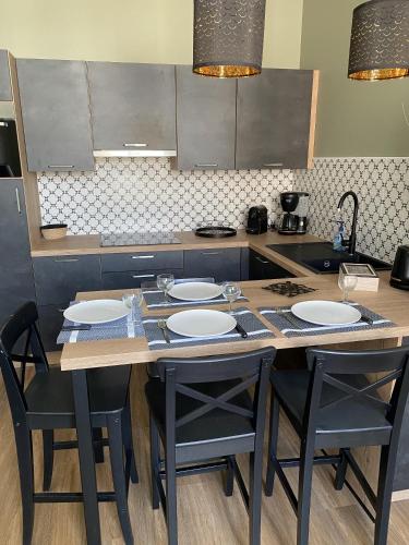 - une cuisine avec une table, des chaises et un comptoir dans l'établissement Marianne 7, à Bergerac