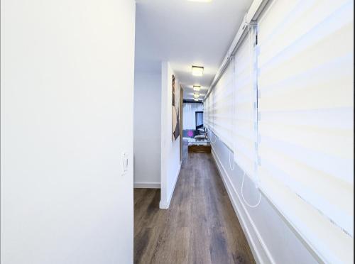 a hallway with white walls and a window at Rancho Las Santas in Guasca