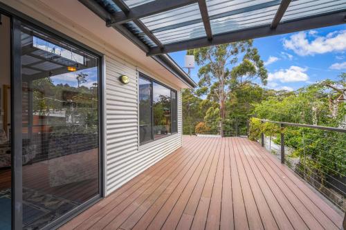 an open porch with a wooden deck at The Shack Port Arthur in Port Arthur