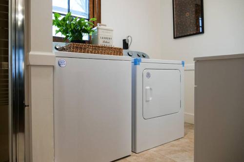 a white refrigerator in a kitchen with a window at Cozy & Convenient Getaway 3BD 2BA Dog Friendly in Akron