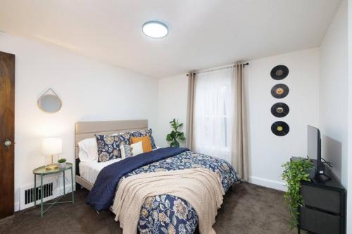 a bedroom with a bed and a television in it at Cozy & Convenient Getaway 3BD 2BA Dog Friendly in Akron