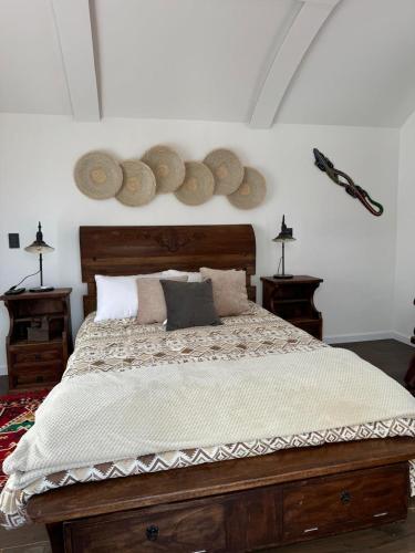 a bedroom with a bed with hats on the wall at Rancho Las Santas in Guasca
