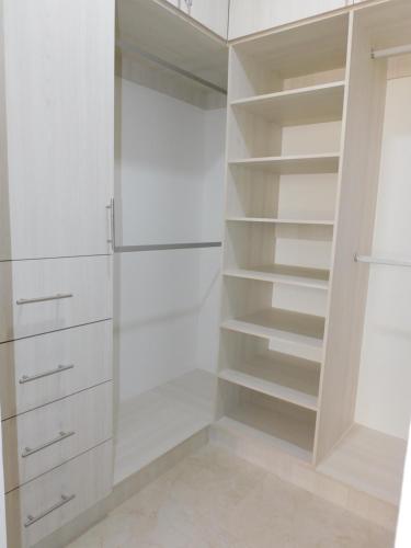 a white walk in closet with white shelves at Gigi's Caribbean Paradise Aparment in Playa del Carmen