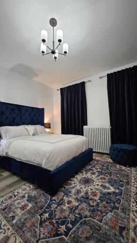 a bedroom with a large bed and a chandelier at Serenity Inn in Niagara Falls